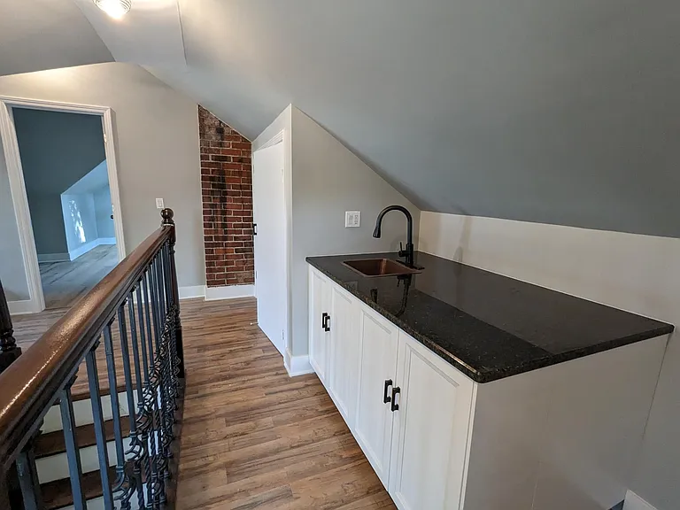 Attic bedroom with bar area.