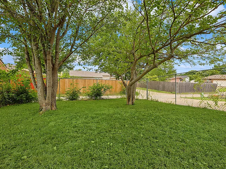 A view of the fully-fenced backyard of the property.