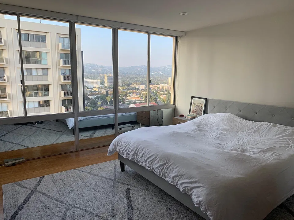 Spacious bedroom with tons of light, remote controlled or wifi-enabled shades, and great views.