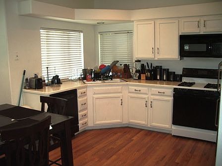 Large eat-in kitchen with hardwood floors.