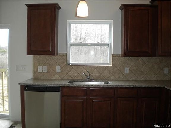 Great view of tree lined backyard from kitchen sink.