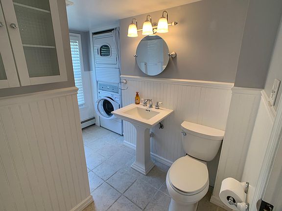 Full bathroom with in unit washer and drier