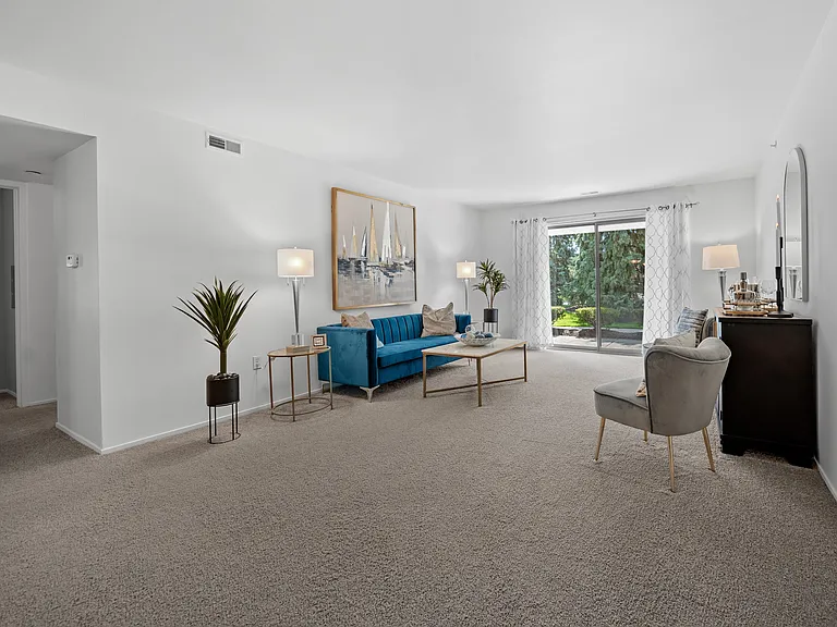 Spacious Living room with patio at Prentiss Pointe Apartments in Harrison Township