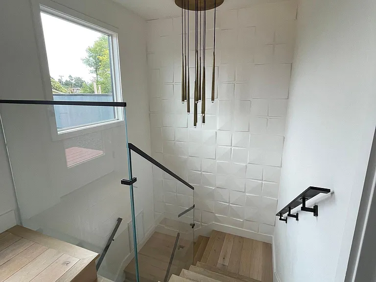 Restoration Hardware chandelier in the stairwell