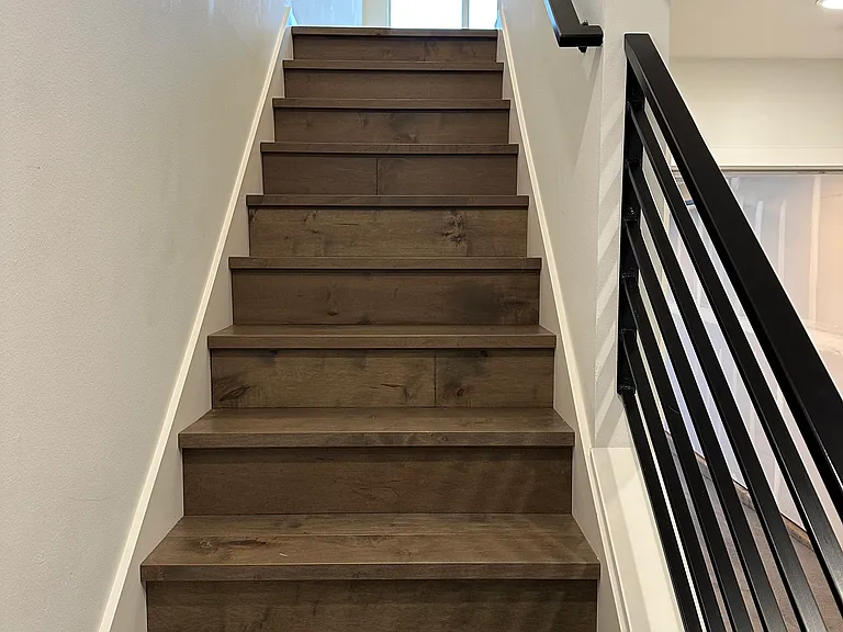 Hardwood stairway leading to main floor.