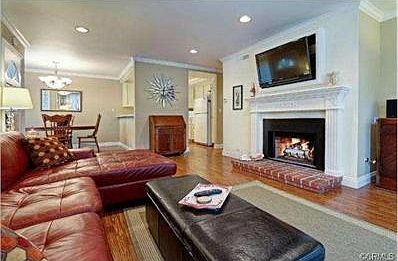 Beautiful fireplace in living room and view to dining area and k