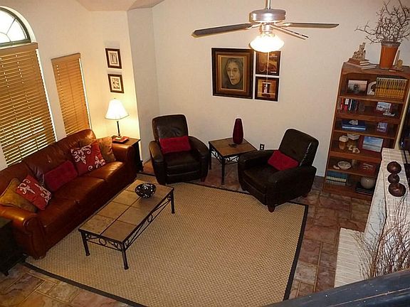 Den with ceiling fan and ceramic tile