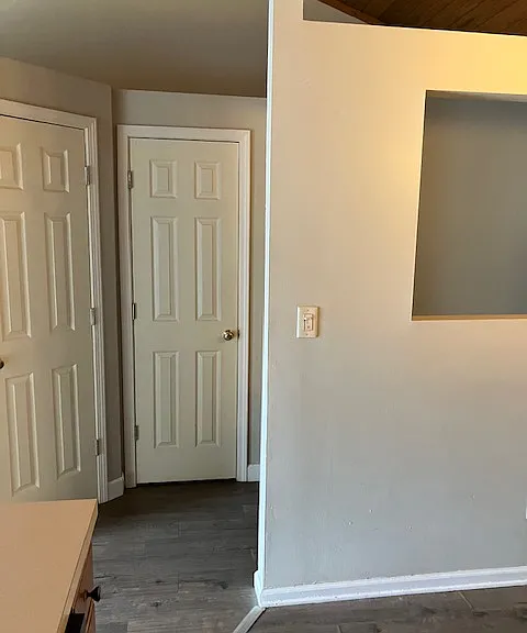 kitchen wall, half bath door on left and storage door on right