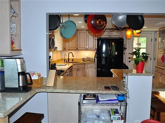 Kitchen with corner coffee station, quartz counter tops  and plenty of cabinets and light.