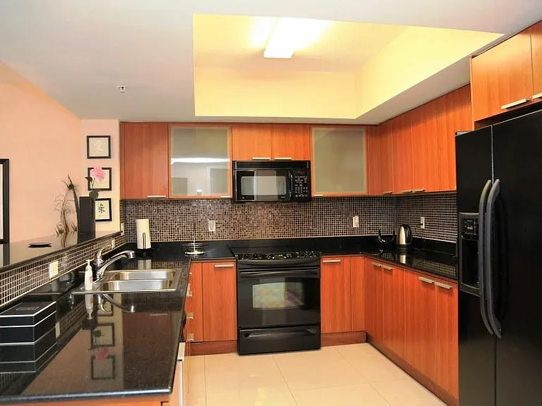 Kitchen with modern cabinetry and granite counter tops