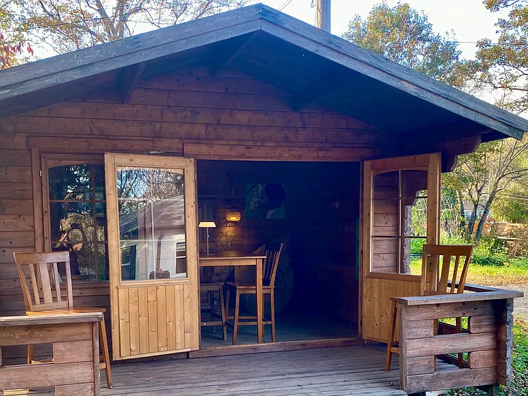 Nordic spruce furnished cabin, with attached deck, greets you upon entering the property and looks out over your huge front yard!