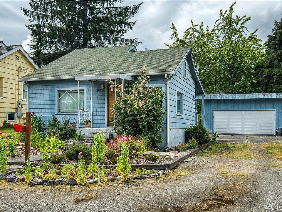 Charming 1920 home in a sweet quiet neighborhood corner with garden space, garage & workroom, walking trails & more