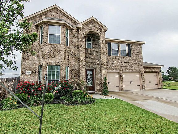 Beautiful brick exterior with bay windows and a 3 car garage with decorative garage doors.