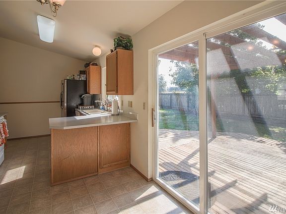 Dining and Kitchen area. nice sized deck leading to the fully fenced back yard