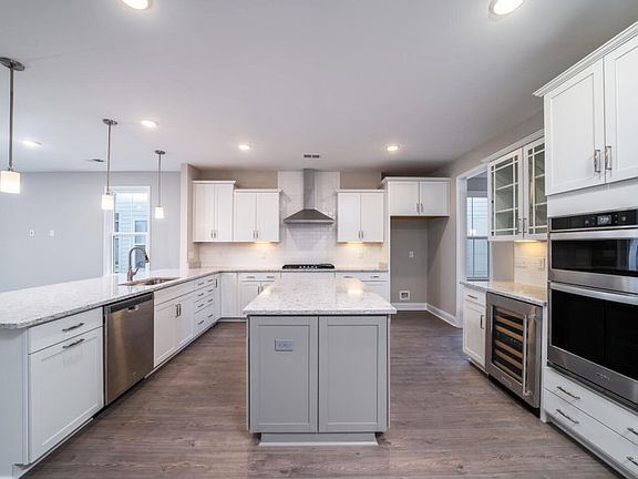 Gourmet kitchen with stainless steel wall oven and large island