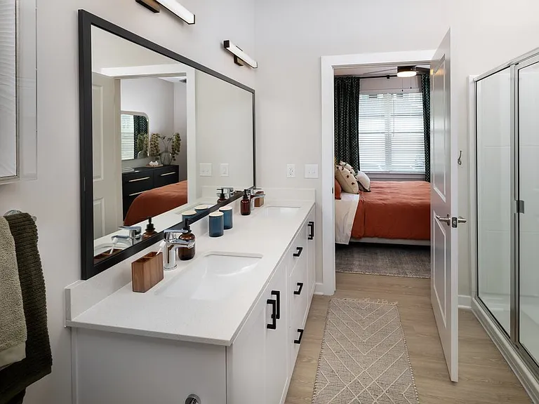 Bath with white shaker cabinetry, white quartz countertop, and hard-surface vinyl plank flooring