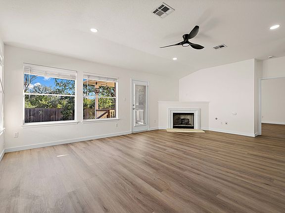 Large living room with a gas fireplace. New LVP flooring