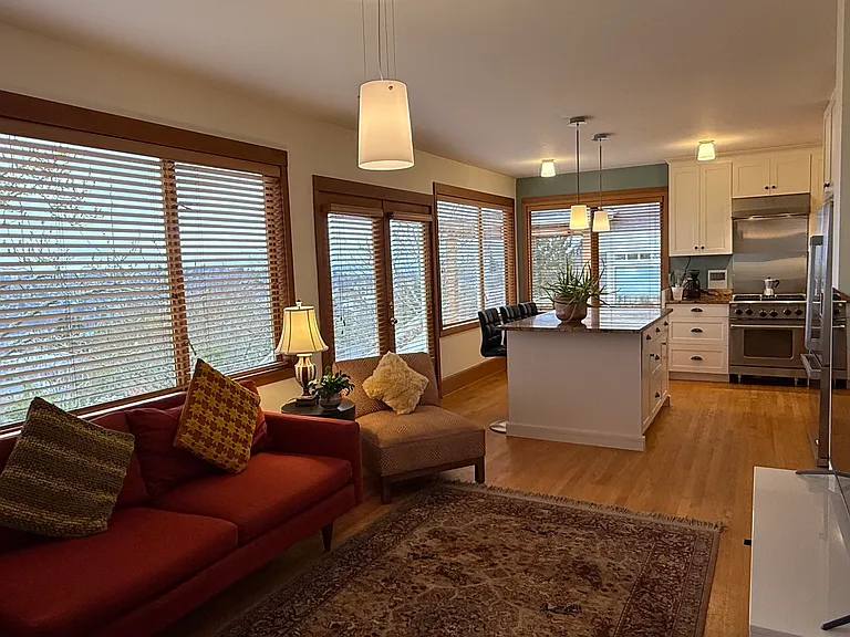 The Family Room looking towards the Kitchen. Beautiful views of the Sound and Olympics.