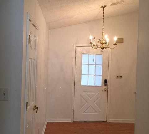 Inside the front door, closet to the left