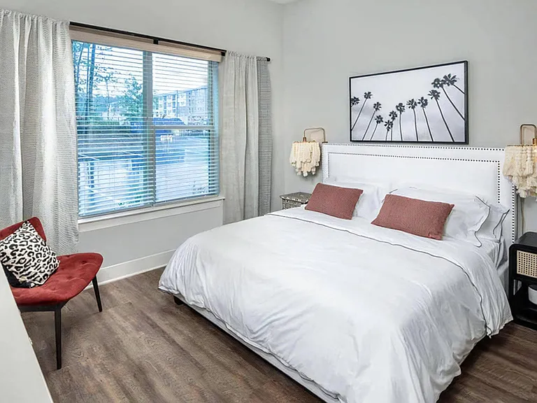 Spacious Bedroom Featuring King Bed, Accent Chair, and Contemporary Decor