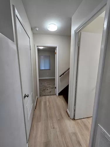 Hallway w/bathroom, laundry closet, pantry, bedroom and stairway - 297 Myrtle Dr