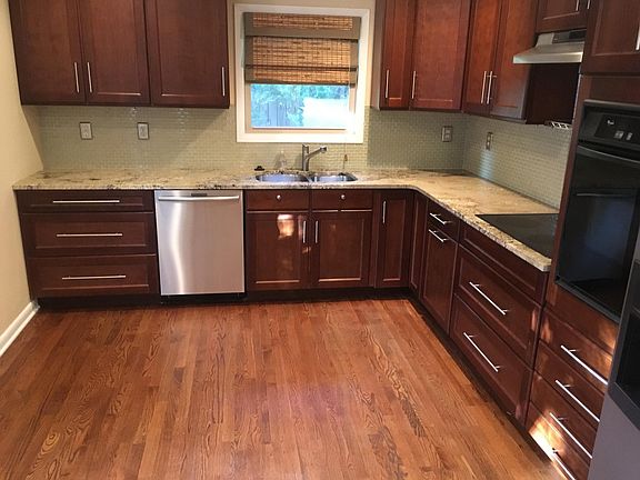 updated kitchen with stainless appliances, cherry cabinets, Bosch dishwasher, new refrigerator.
