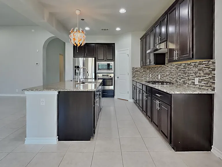 Spacious kitchen with dark cab