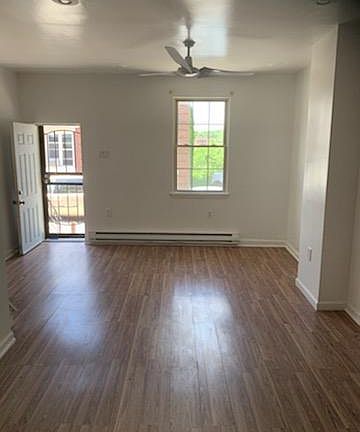 Living-room with New Ceiling fan , highlights, and hardwood floor