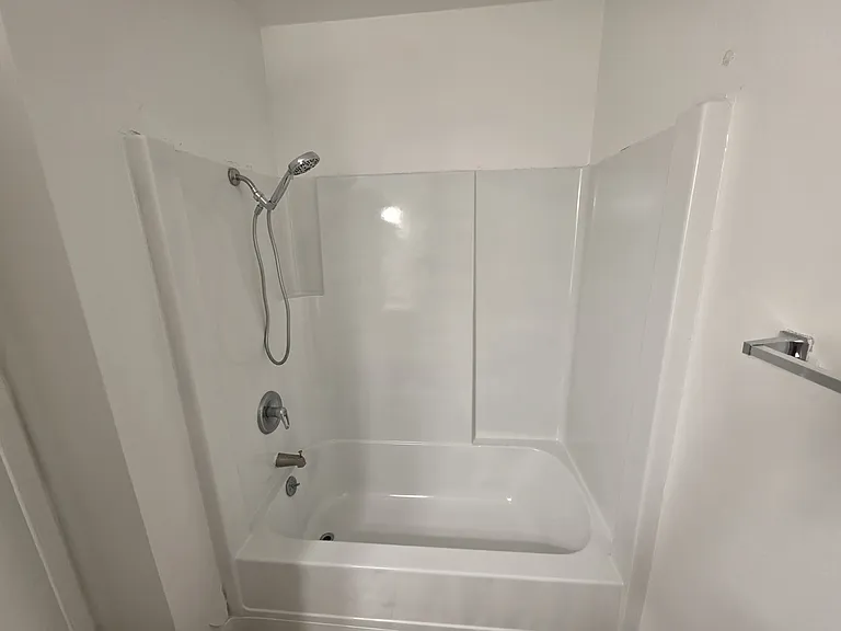 Hallway bathroom with tub