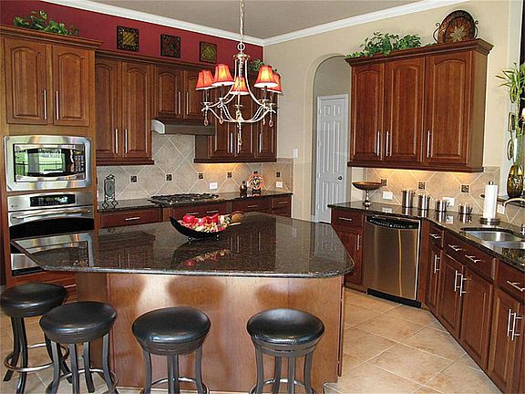 INCREDIBLE Chef inspired kitchen featuring stainless steel appliances,  gas cooktop along with built-in oven & microwave!!