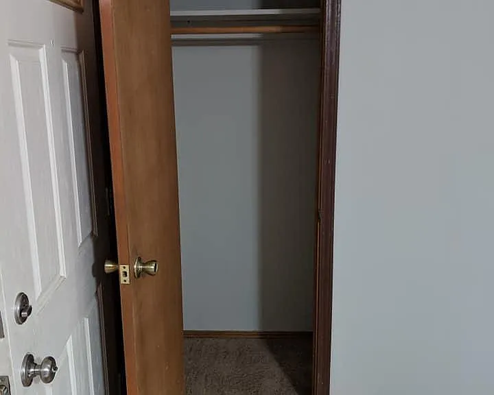 Living room coat closet behind front door