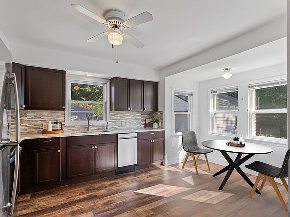 Spacious, renovated eat-in kitchen overlook grassy backyard & woods