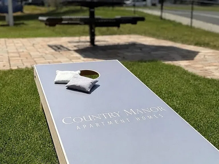 The cornhole area at Country Manor Apartment Homes offers residents a casual place to connect with neighbors, enjoy friendly competition, and spend time outdoors in a welcoming community setting.