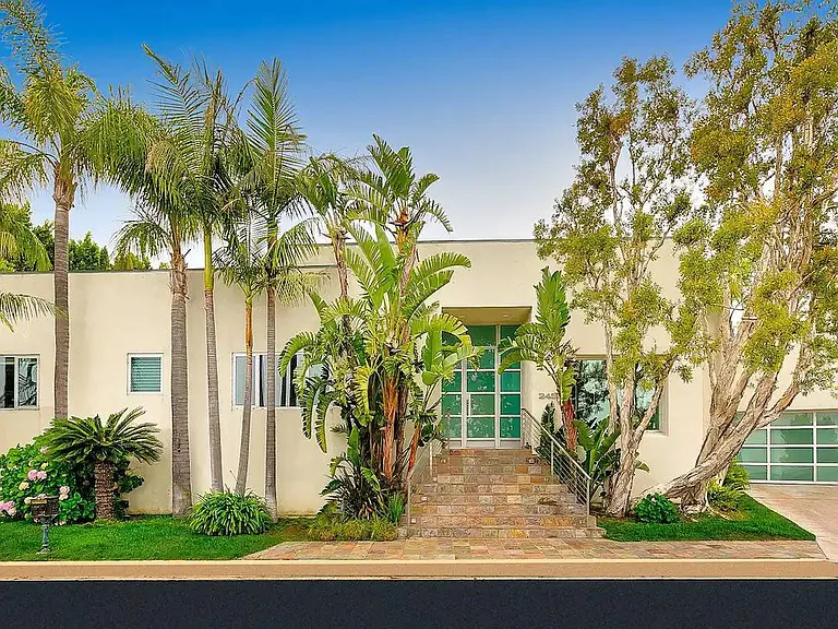 Step into the home entrance adorned with palm trees, welcoming you to your private oasis.