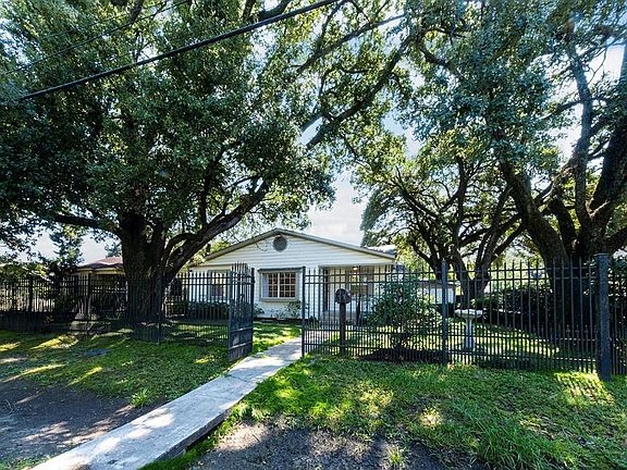 This beautifully wooded corner lot is fully fenced, with driveway/garage access on Paine Street.