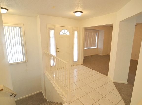 Foyer- open entry with coat closet to the right of the stair case.