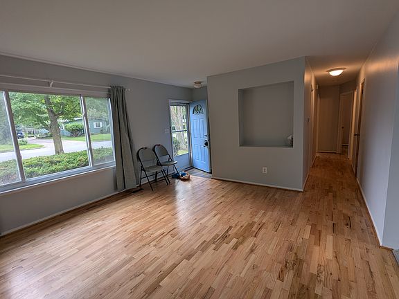 Light filled living room, refinished hardwood floors