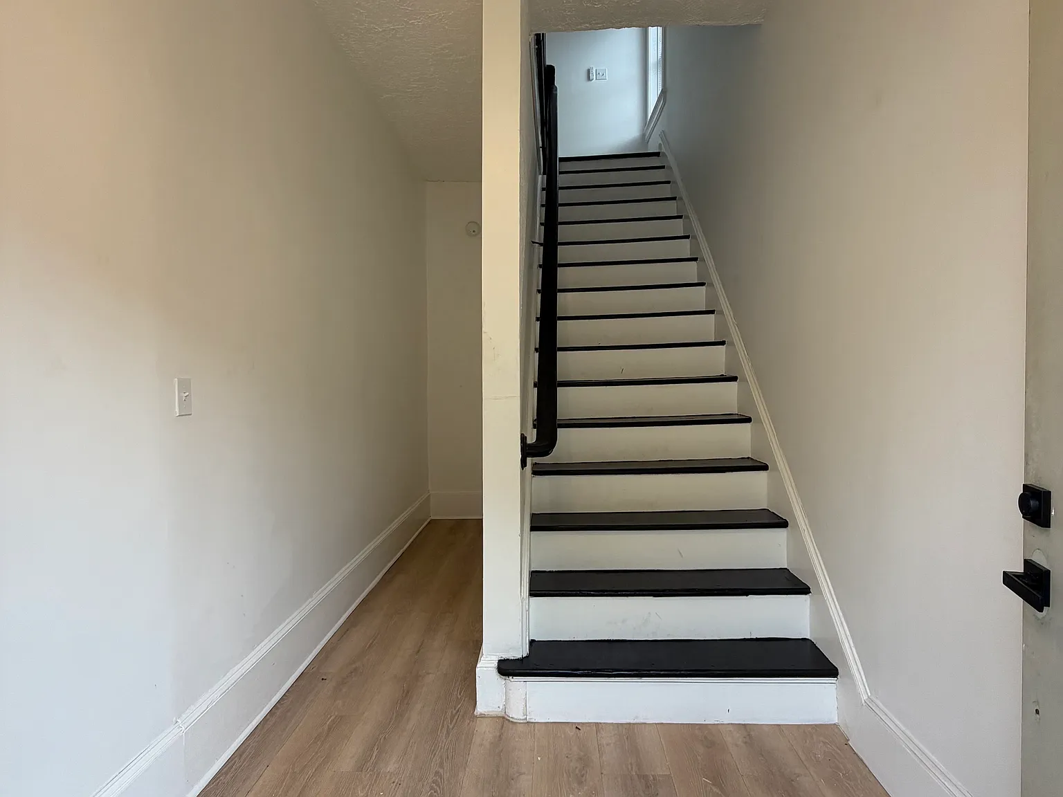 Entryway with ample storage for a bike or a stroller.