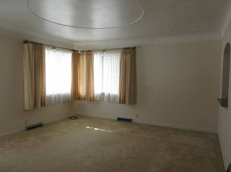 Living room offers hardwood floors under carpet