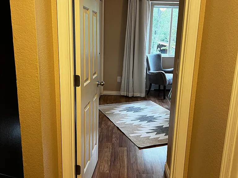 view from second bedroom to primary bedroom