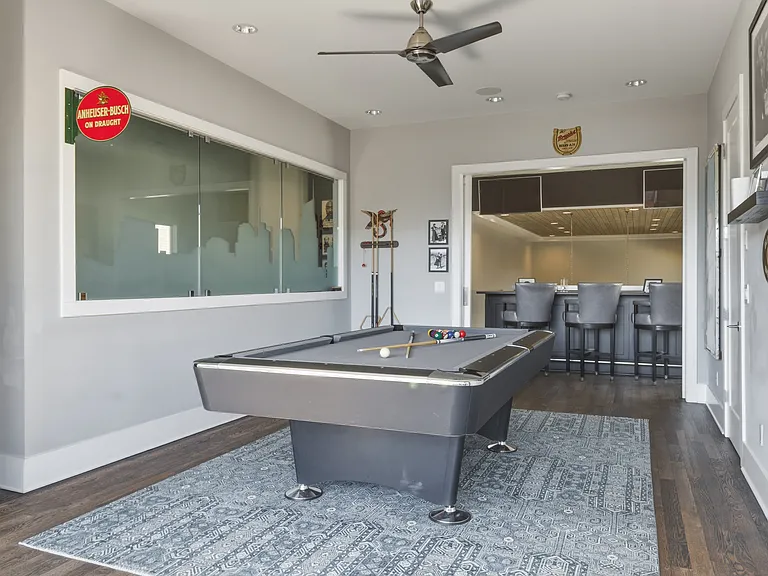 Upstairs game room connected to the rooftop patio and mini bar_an ideal hangout space for friendly competition and evening cocktails.