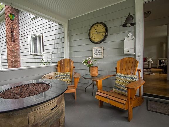 The welcoming side porch...where you will spend most mornings with coffee and evenings with a fire.