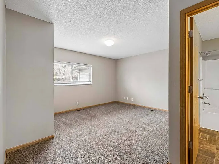 A comfortable bedroom with an adjoining bath offers a quiet retreat designed for everyday comfort and convenience.