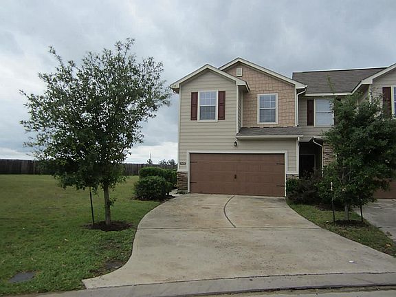 Full driveway view, showing empty lot next to unit.