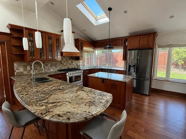 Kitchen with operable skylight, pot filler, Lutron lighting system, undercounter and uplighting, undercounter microwave, secondary sink, baseboard vents, warm in winter cool in summer. Smeg 36" oven