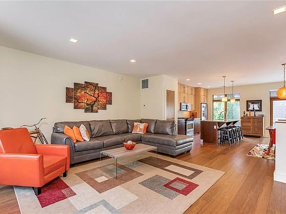 A wide-open main floor plan allows for a myriad of furniture placements. The sustainable bamboo flooring is easy to care for and