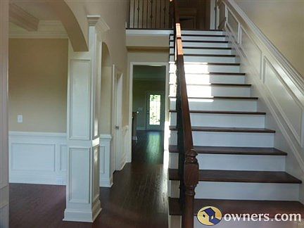 Gorgeous two story foyer with upgraded wrought iron banister