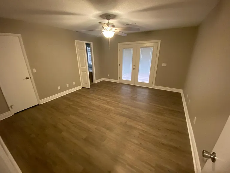 Master Bedroom with French doors out to the deck with walk in closet and master bathroom.