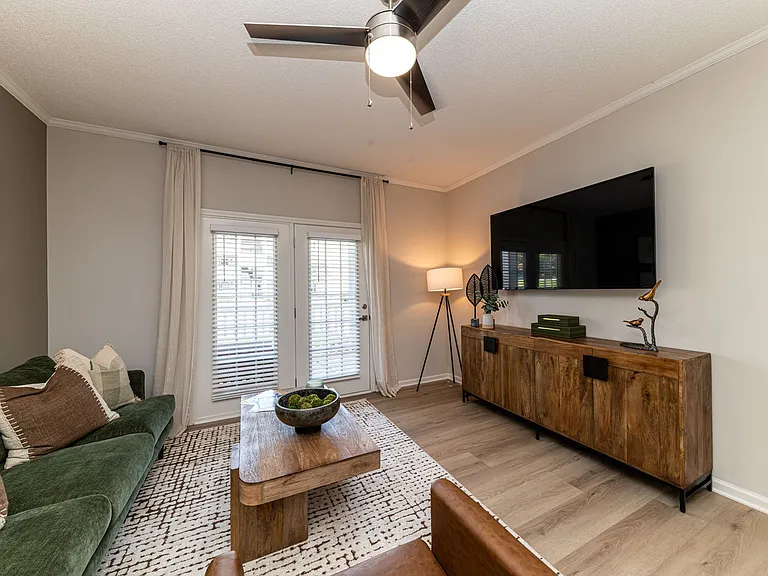 Spacious living room with hardwood-style flooring and overhead lighting