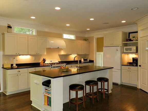 Large open kitchen features a top of the line Aga range and hood, lots of honed granite counter spac